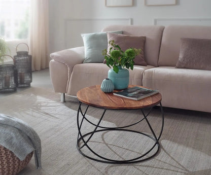 A round coffee table with a Solid sheesham wood top and black metal base.