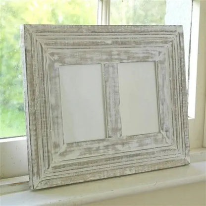 A rustic white photo frame made of mango wood with a distressed finish, designed to hold two photos.