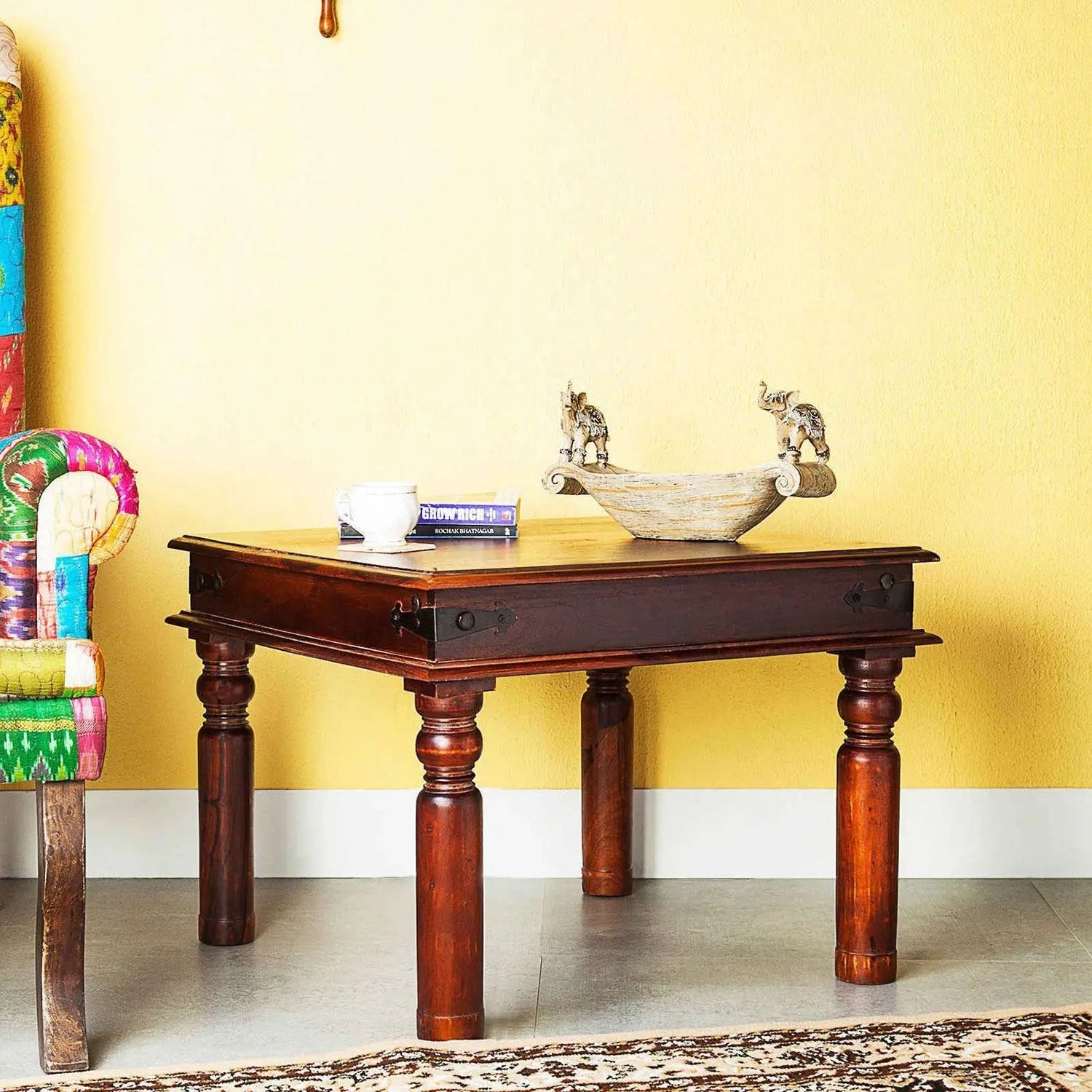 A rectangular brown solid sheesham wood Sangy coffee table with four legs. 