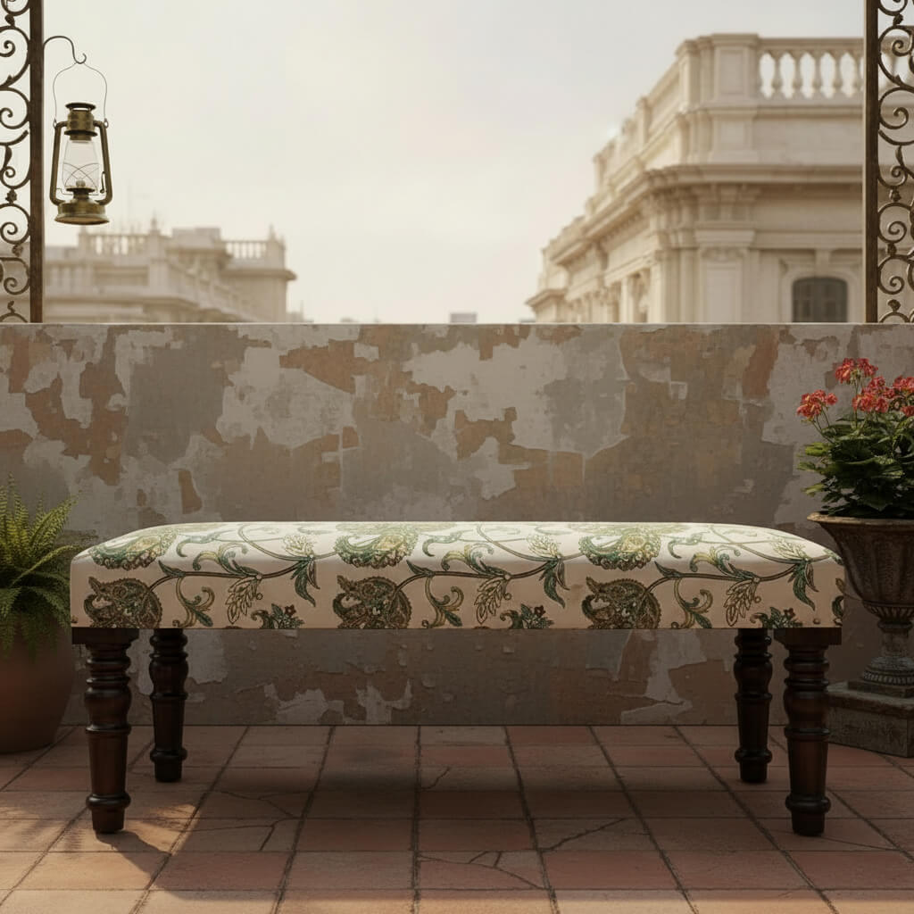 A floral upholstered bench with wooden legs.