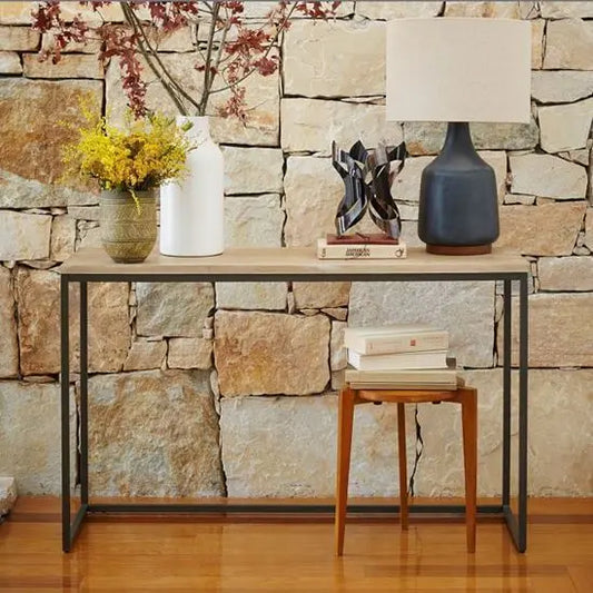 An open console table made of mango wood and mild steel.