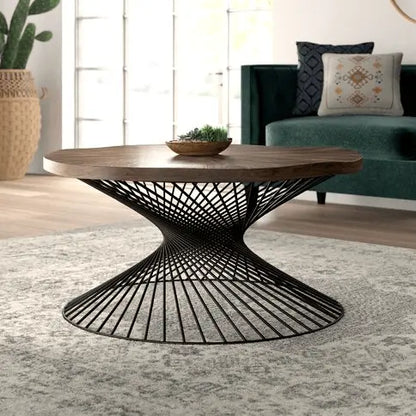 A round Sprial coffee table with a mango wood top and a black metal sprial base.