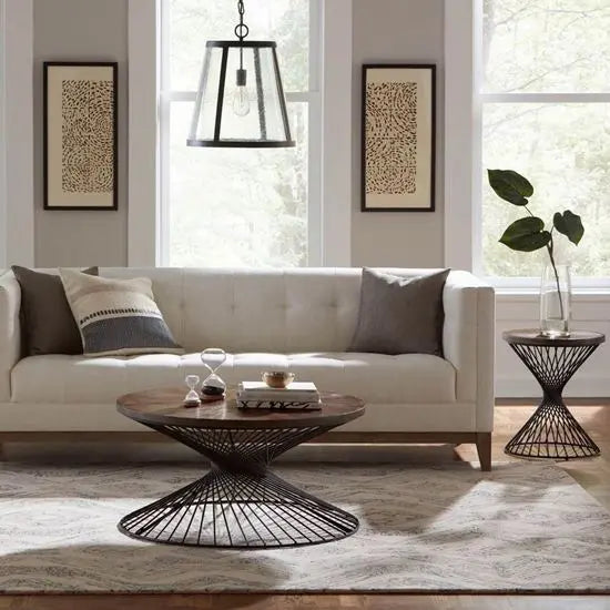 A round side table with a sheesham  wood top and metal base.