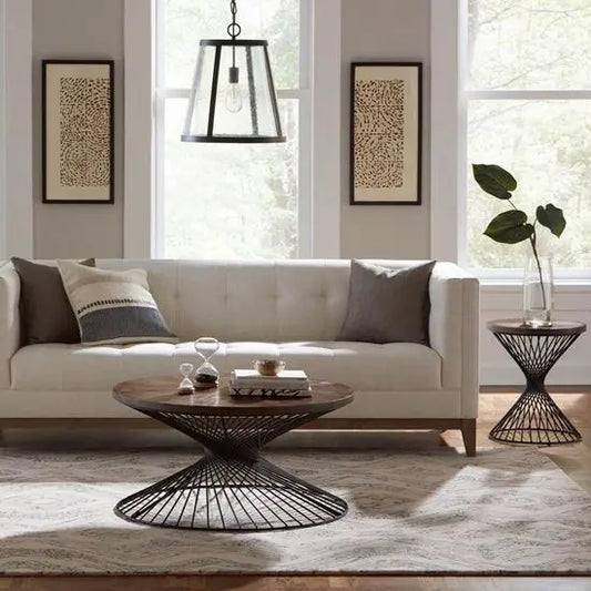 A round side table with a sheesham  wood top and metal base.