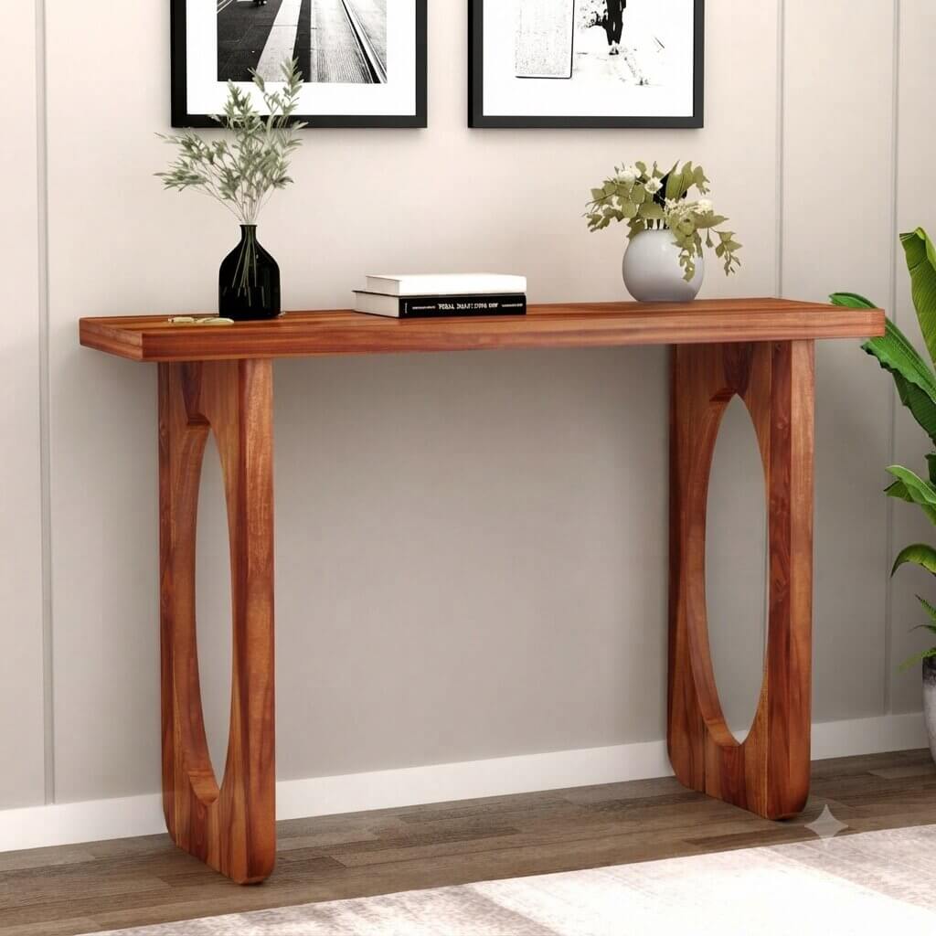A mid-century modern console table with a warm brown wood finish, featuring oval cutout legs.