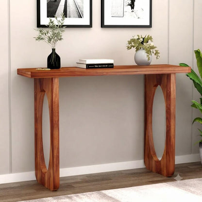 A mid-century modern console table with a warm brown wood finish, featuring oval cutout legs.