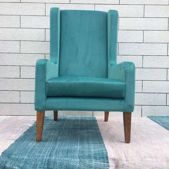 Wooden Modern design wing chair in natural finish with green velvet fabric. 