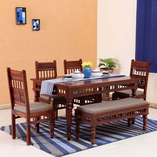 A vintage-style dining set made of sheesham wood, including a rectangular table.
