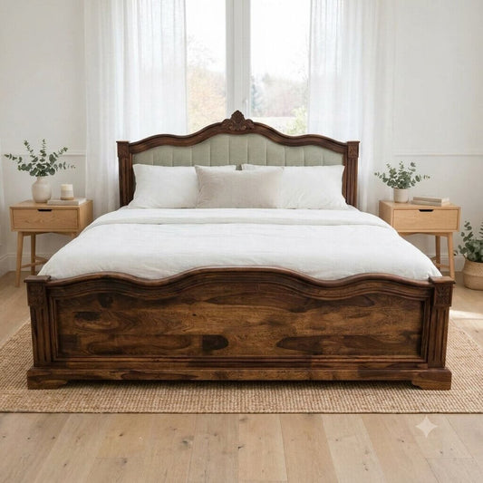 A solid wood bed frame with a carved headboard and footboard.