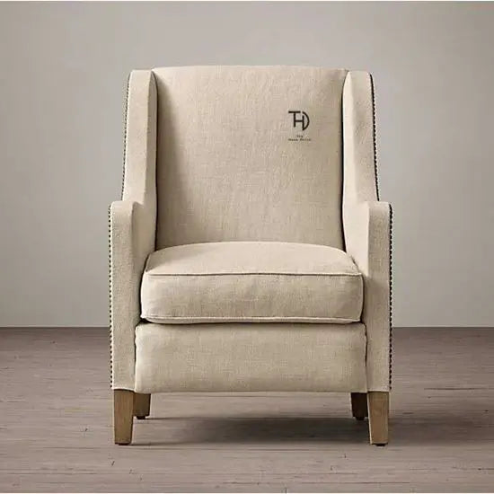A Zack Sofa featuring a cream color fabric and Sheesham wood frame, with a sleek design.