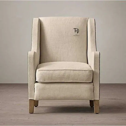 A Zack Sofa featuring a cream color fabric and Sheesham wood frame, with a sleek design.