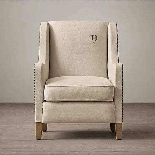 A Zack Sofa featuring a cream color fabric and Sheesham wood frame, with a sleek design.